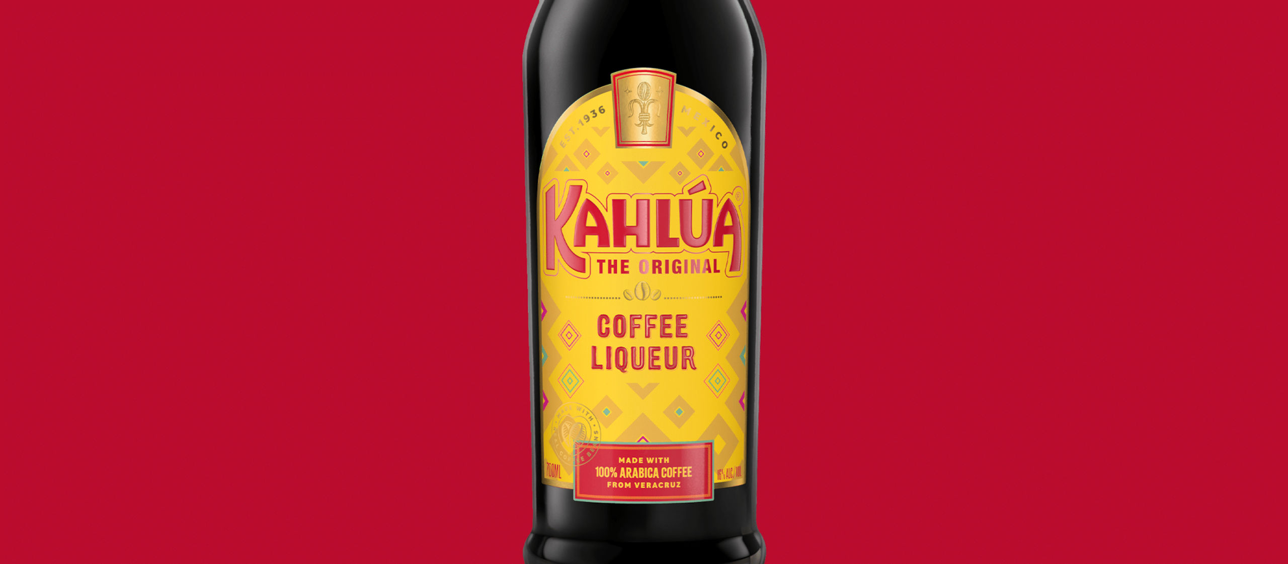 Kahlua Original Coffee Liqueur bottle against a red background