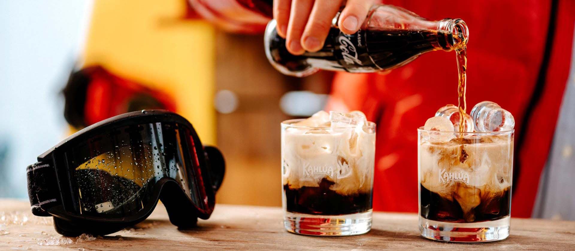 Kahlua and coca cola drink being poured at the Apres Ski