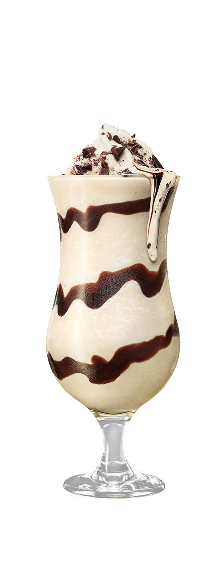 Frozen Mudslide drink garnished with crushed chocolate in front of a transparent background