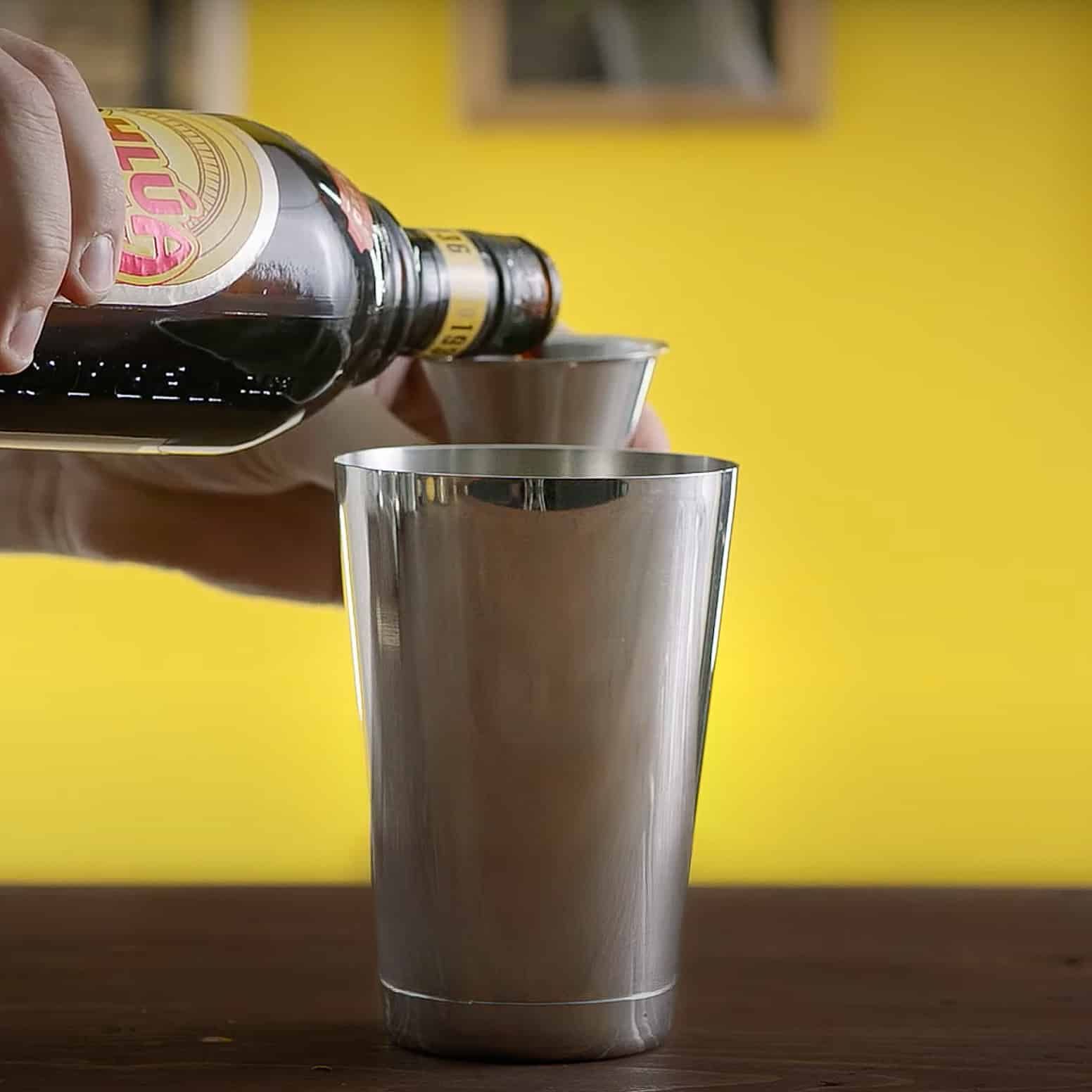 Kahlua being poured into shaker