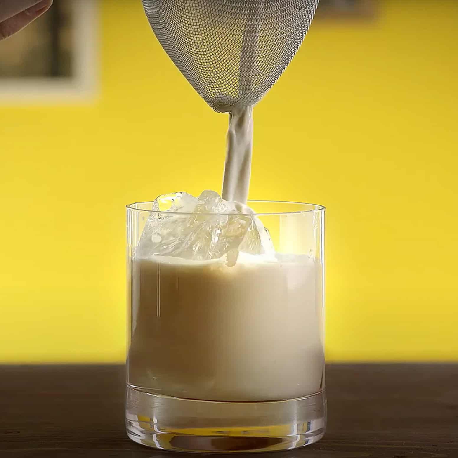 Mudslide being strained into rocks glass with ice