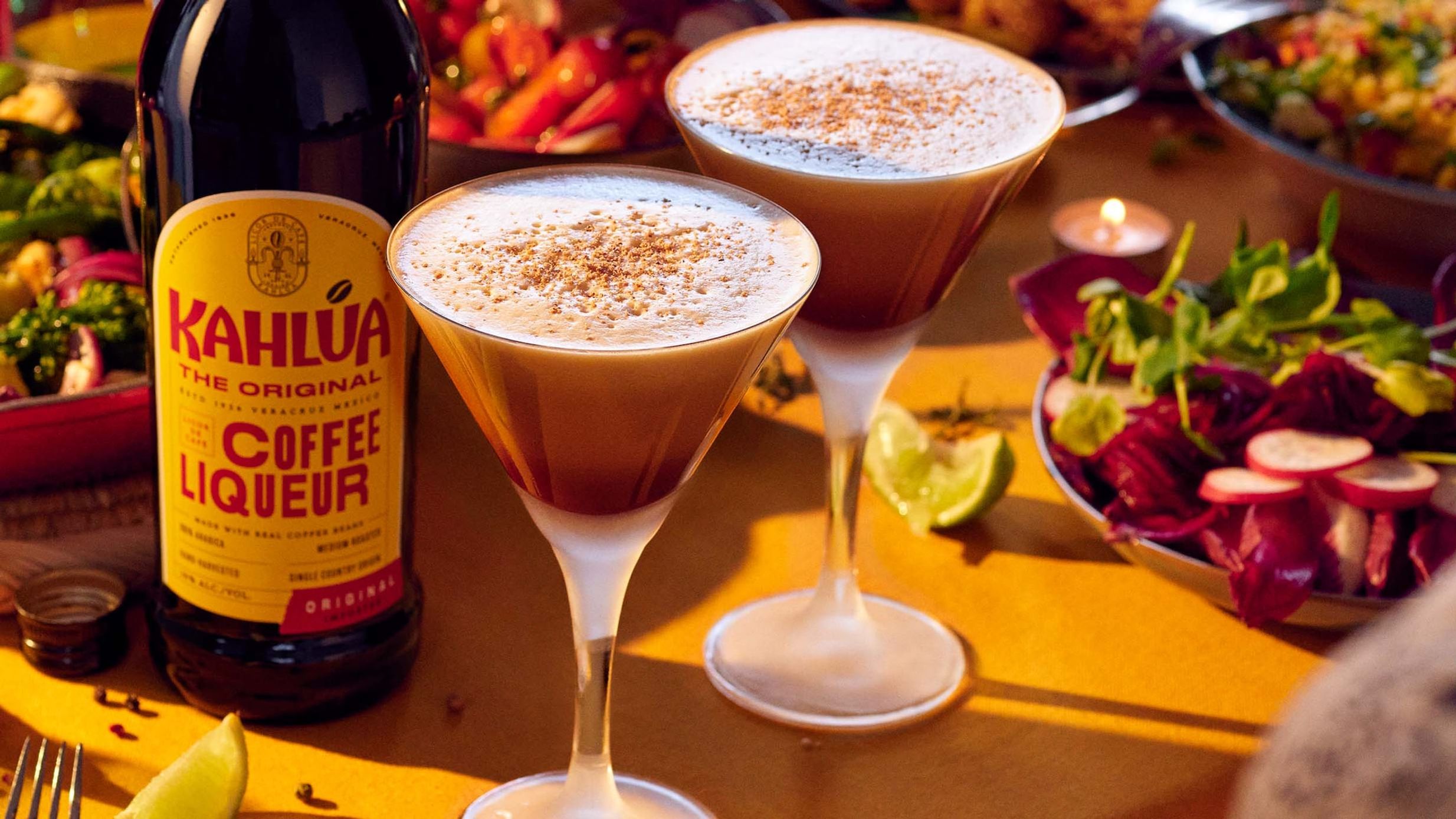 Two Pumpkin Spice Espresso Martini on a table with food