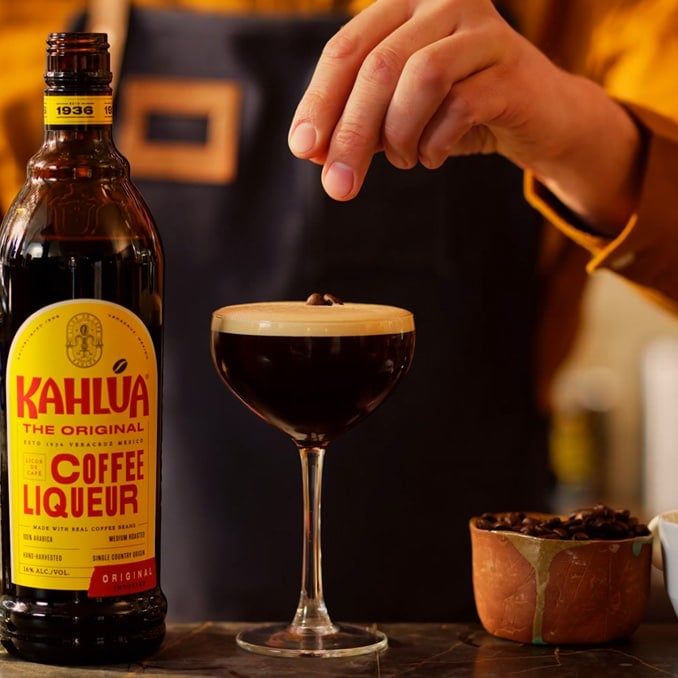 Garnishing Tequila espresso martini with coffee beans