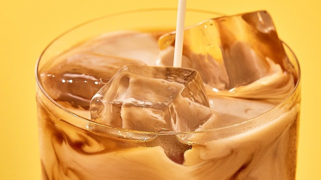 White russian cocktail close up on a yellow background