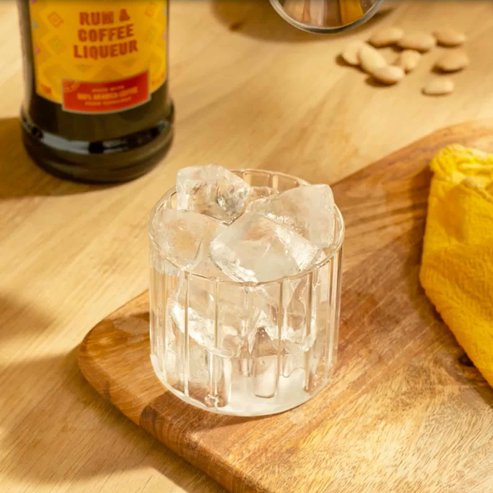 Ice being poured into a rocks glass