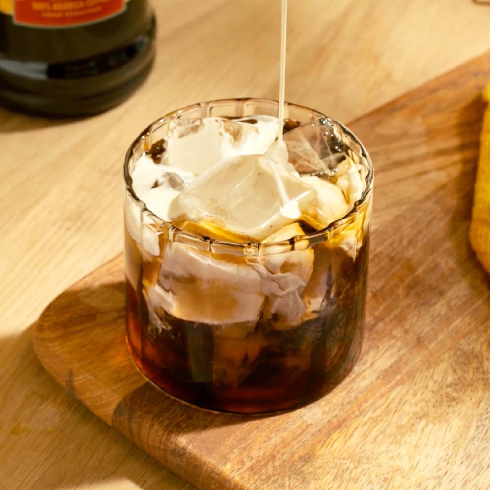 Cream being poured into the rocks glass