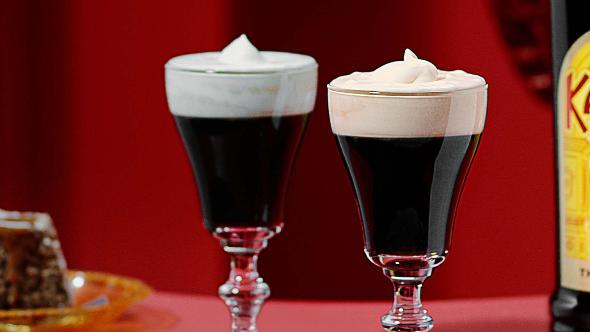 Two Kahlua Irish Coffees on a red background