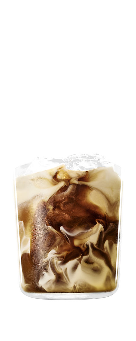 Kahlúa and Milk drink garnished with ice in front of a transparent background