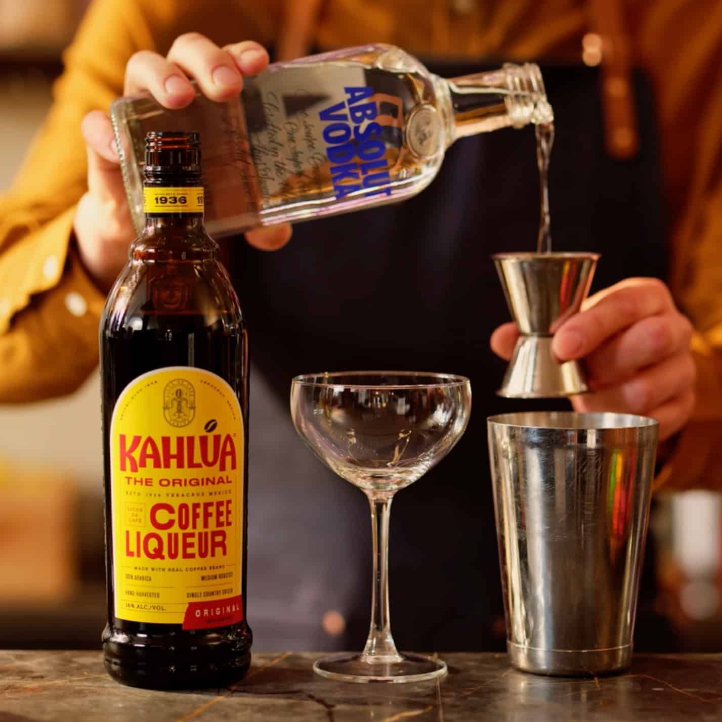 Absolut vodka being poured into shaker