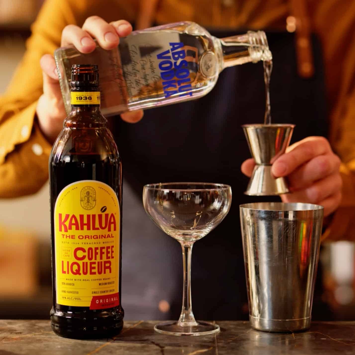 Absolut vodka being poured into shaker