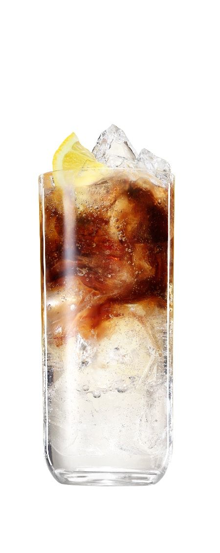 Kahlùa gin and tonic drink garnished with a lemon slice in front of a transparent background