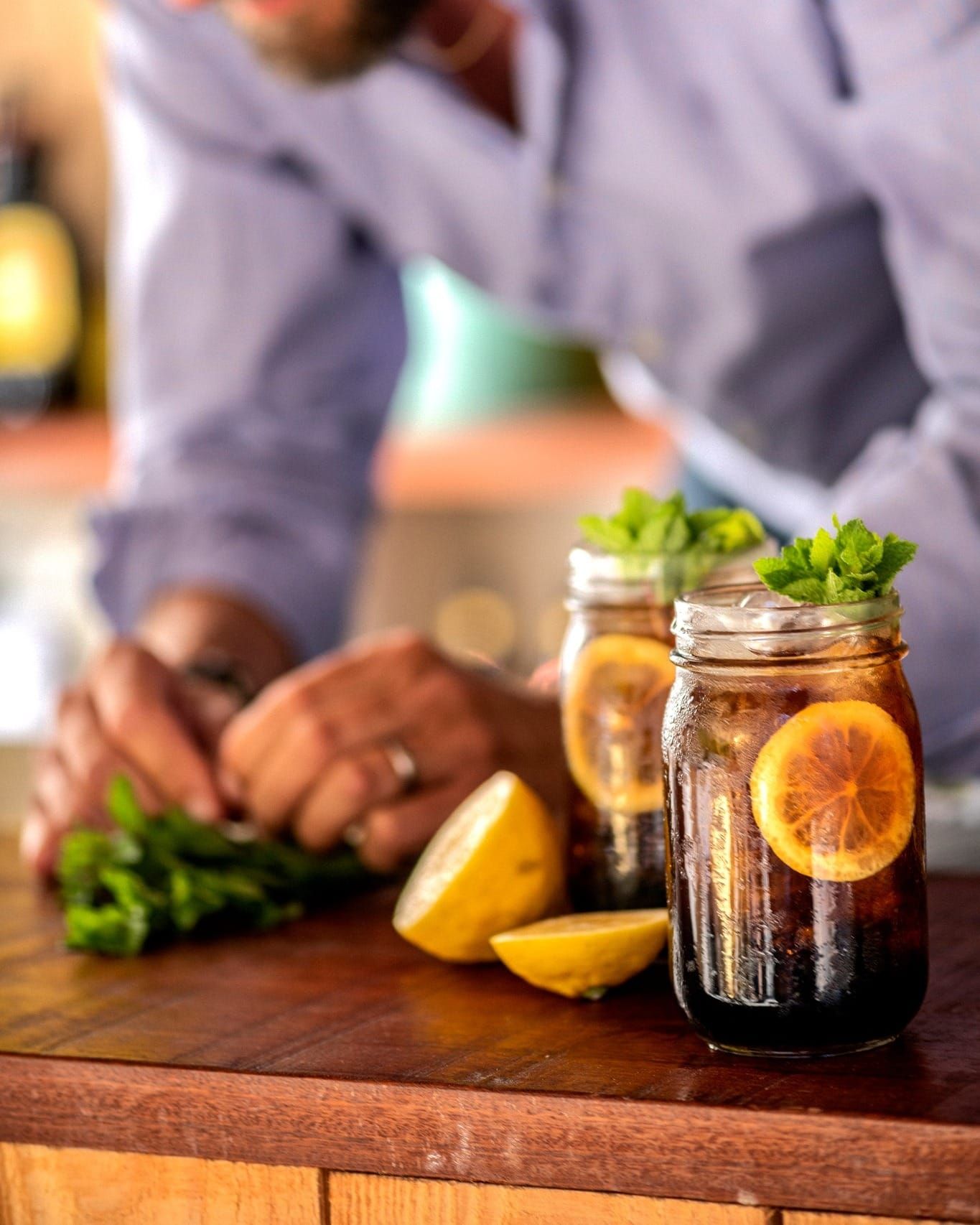 Two Kahlua cocktails with mint and lemon on a table