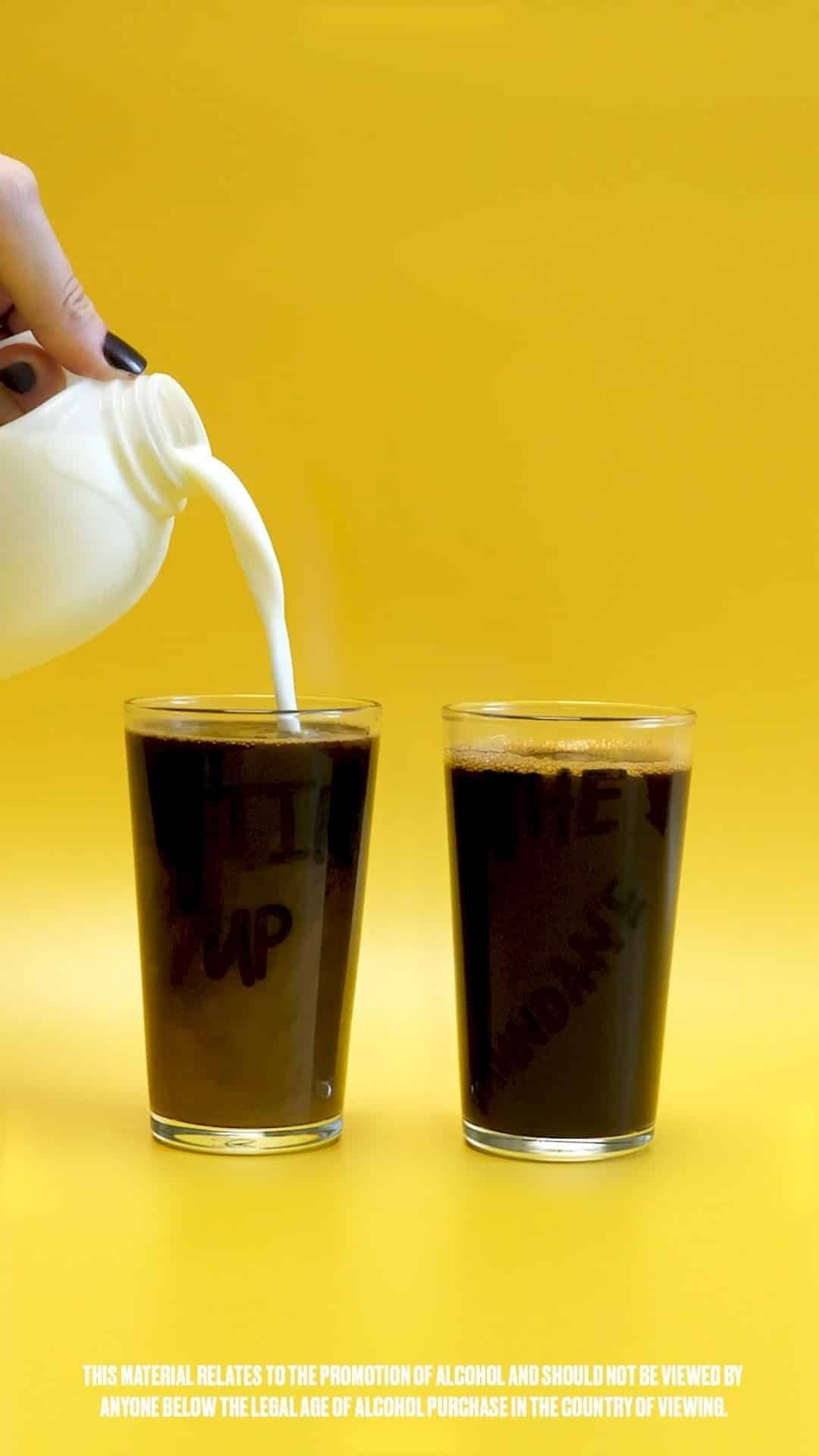 Two glasses of Kahlua and adding a milk to them