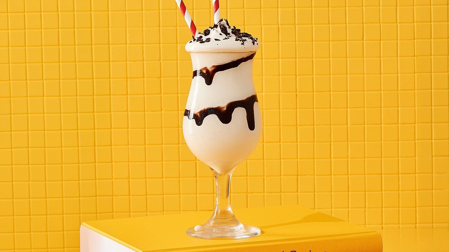 Dirty Banana Frozen frappe on a yellow background