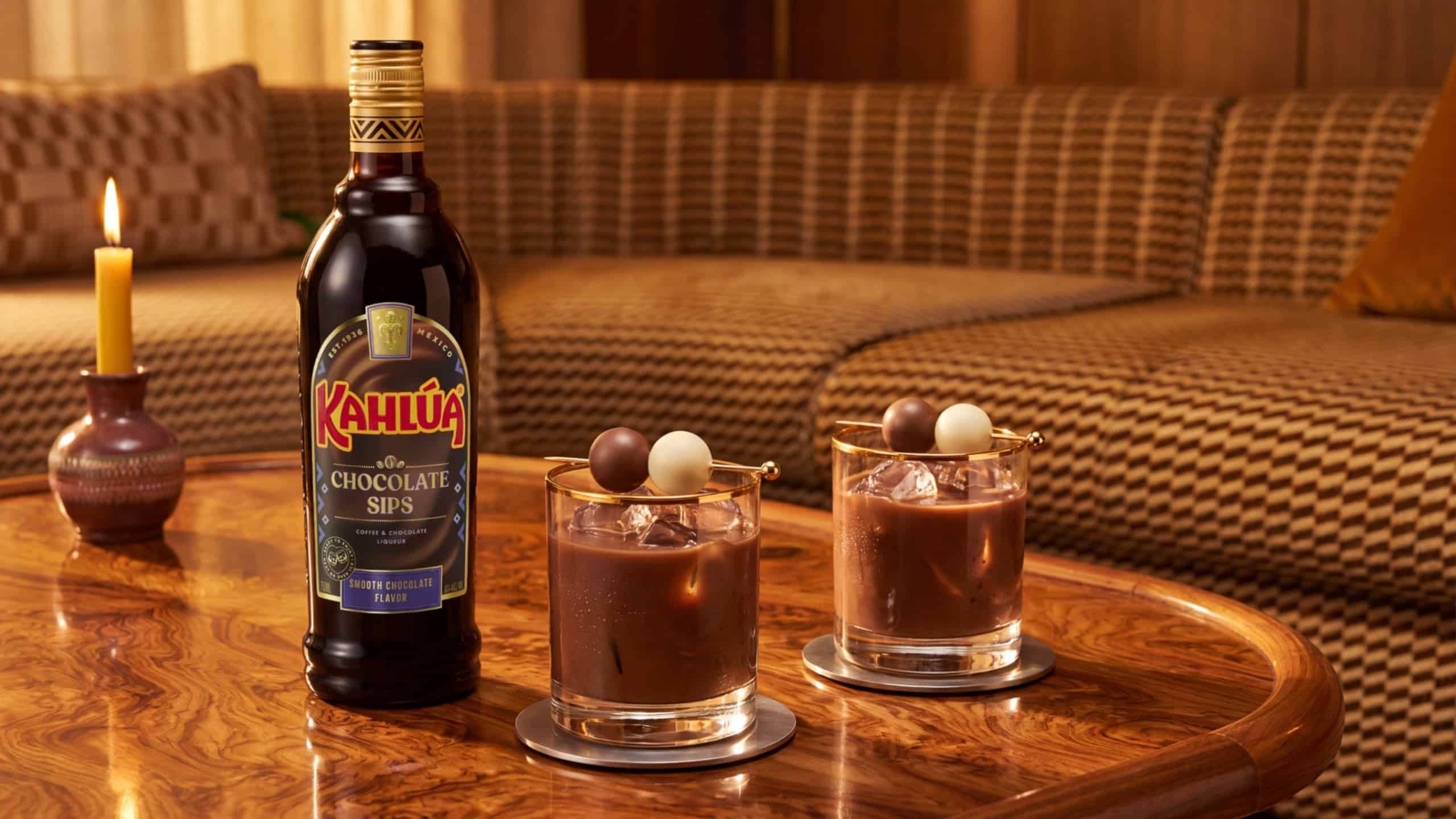 Kahlua Chocolate Sips bottle on table with two neat drinks