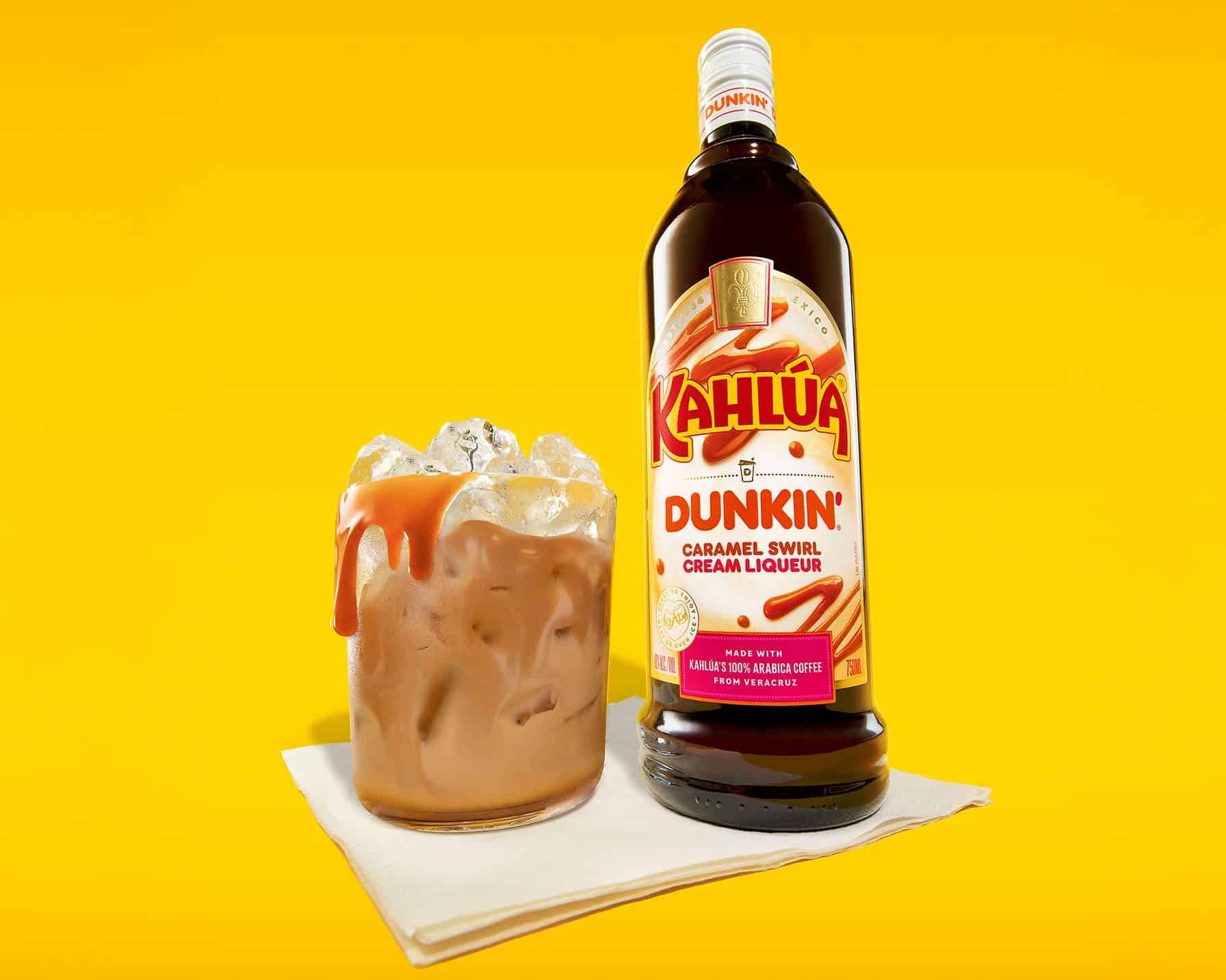 Dunkin' Kahlúa Caramel Swirl Cream liqueur next to a drink over ice