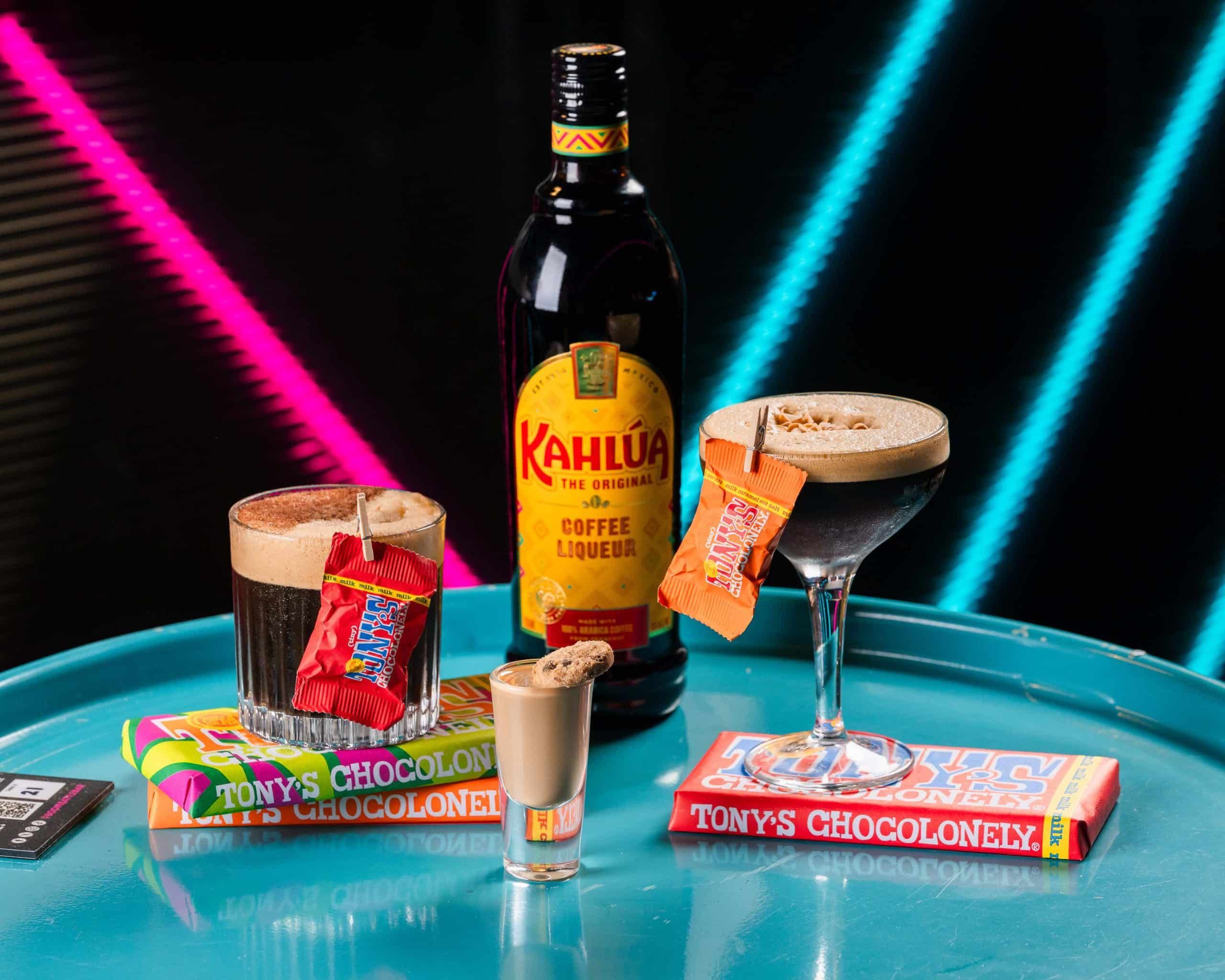 Kahlua Bottle, Kahlua cocktails, and Tonys chocolates on a table in Boom Battle Bar location