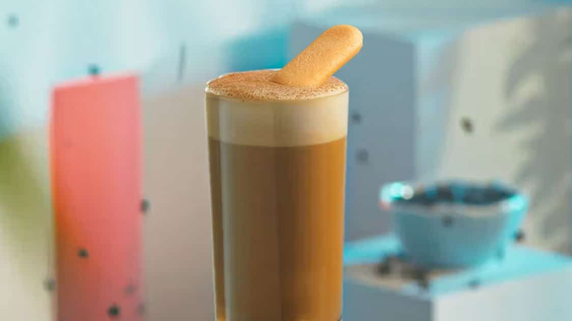 Kahlua Tiramisu Latte in a highball glass with a ladyfinger garnish