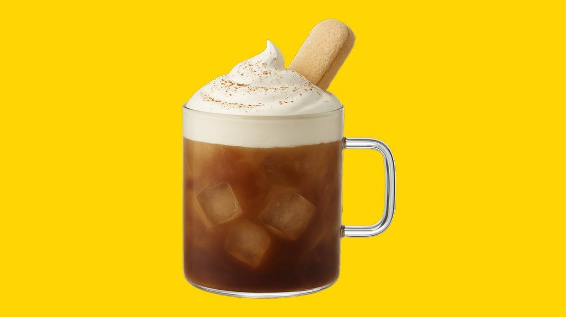 Kahlúa tiramisu iced latte garnished with a ladyfinger biscuit in front of a yellow background