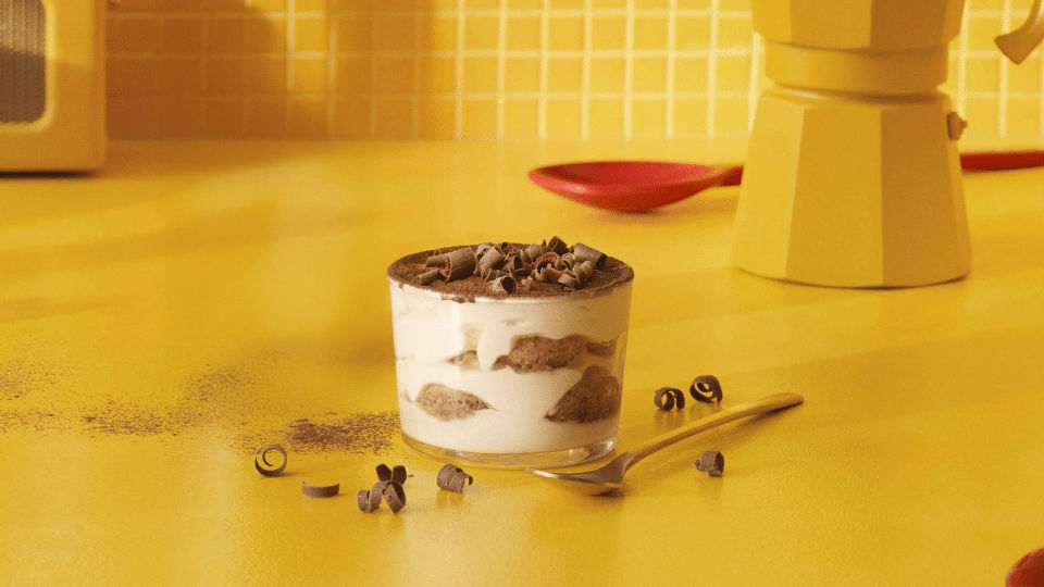 Kahlúa Tiramisu served in a glass bowl garnished with cocoa powder