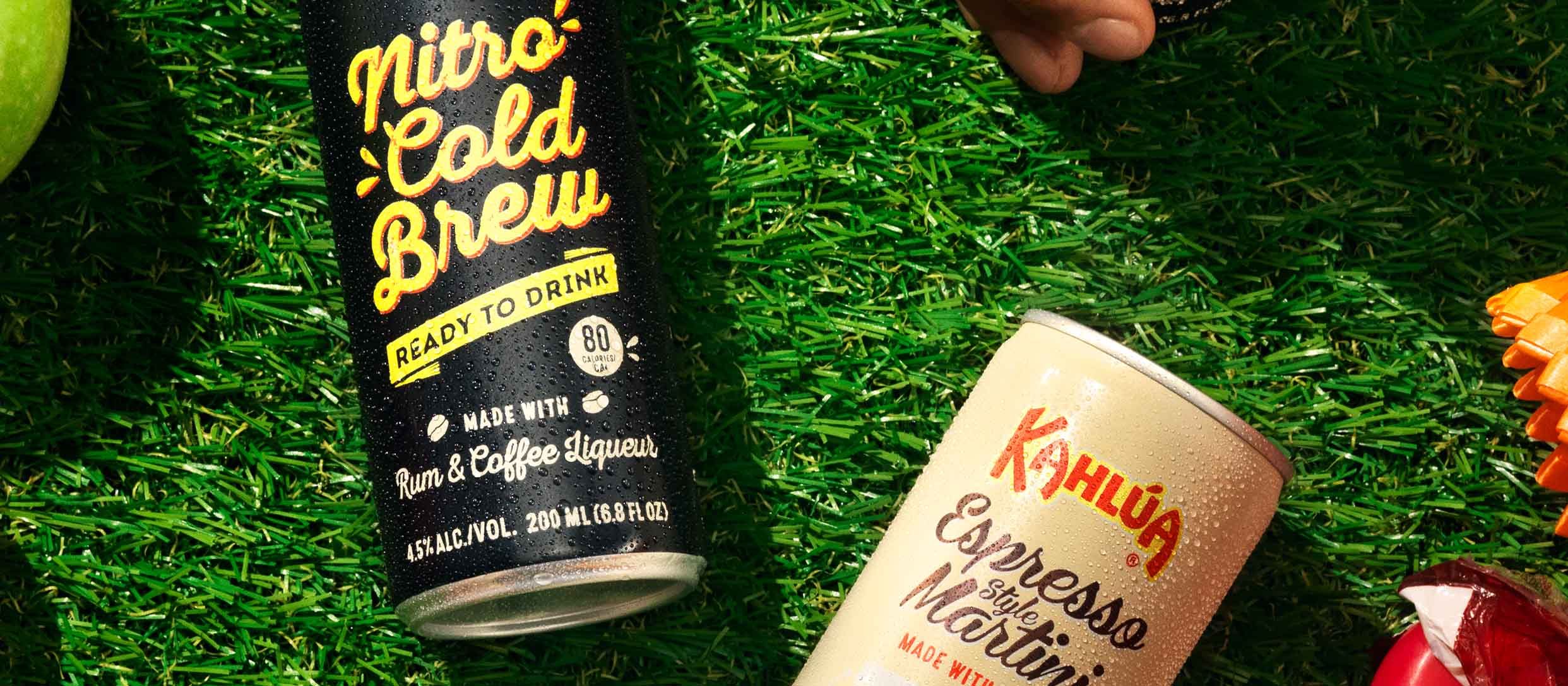 Kahlua Nitro Cold brew Can and Espresso martini can laying on grass